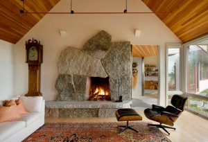 Irregular-shaped, weathered granite fireplace with a raised hearth